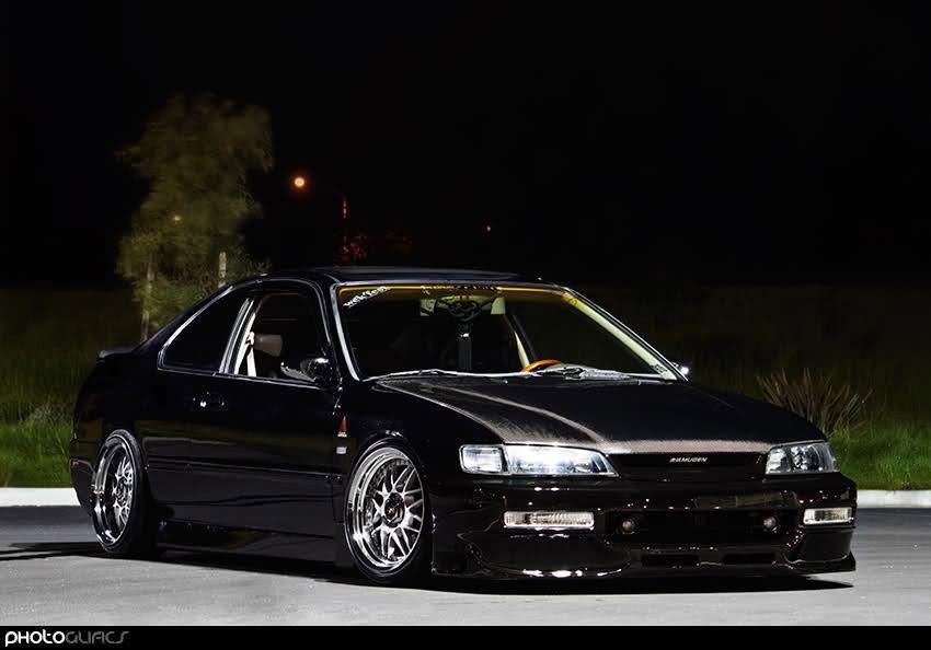 Black modified coupe photographed at night